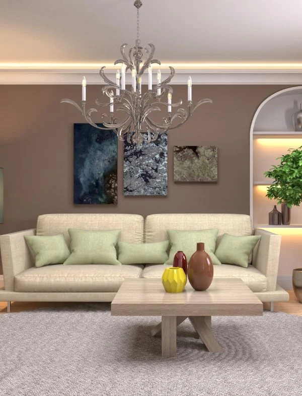 Modern luxury living room featuring a cream upholstered sofa, sage green pillows, a large silver candle-style chandelier, and abstract wall art.