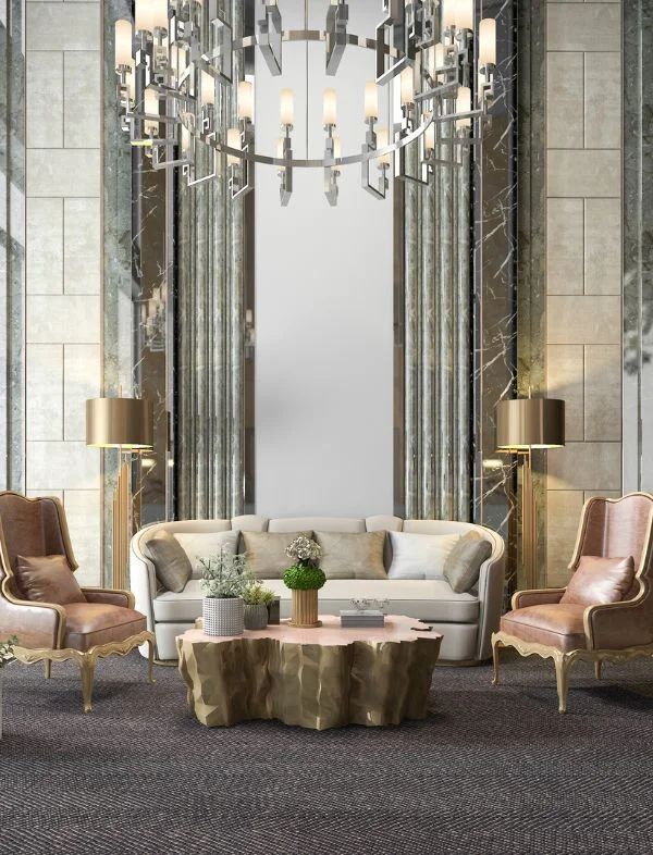 Luxury glamorous living room featuring a grand oversized silver ring chandelier, a sculptural gold-base coffee table, and floor-to-ceiling marble and mirrored wall panels.
